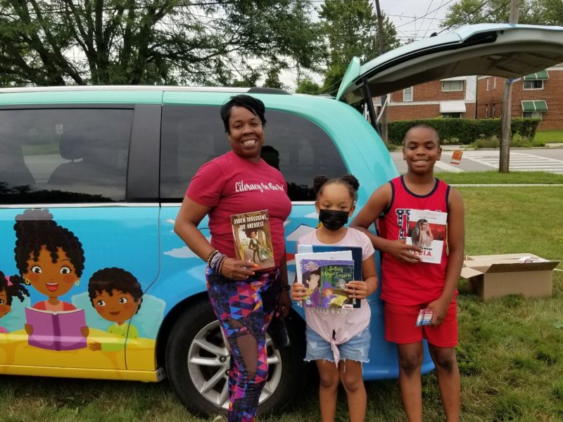 Chrisawandra Matthews and children standing near van