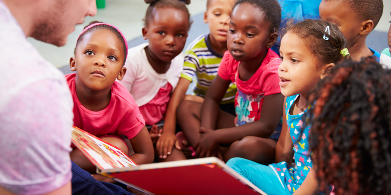Students sitting to listen to a story