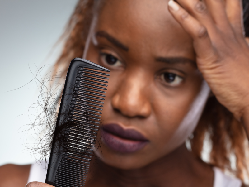 Black woman holding comb
