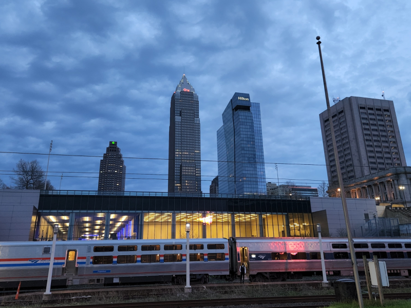 Cleveland skyline at dawn as Amtrak train passes