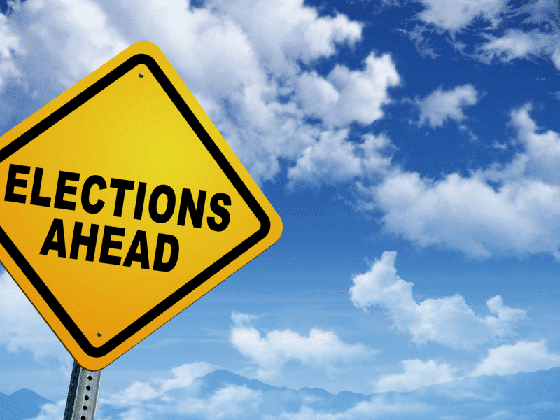 Features and intro image of sign that says Elections Ahead
